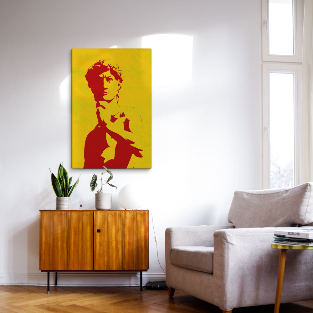 Red Classical Statue Canvas Print above a wooden cabinet and armchair, ideal for retro revival living room decor.