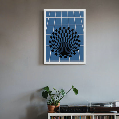 3D optical illusion art print shown in a white frame hanging on a light gray wall. The black checkered vortex on blue grid background creates a visual depth effect. Below the print sits a wooden shelf or surface with books and a small green plant.
