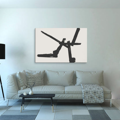A minimalist black brushstroke abstract canvas print hangs above a modern light gray sofa, creating a striking contrast in a contemporary living room. The neutral-toned decor and subtle lighting make the artwork stand out as a bold statement piece.