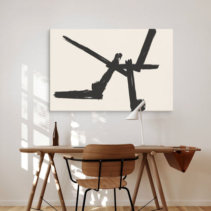 A bold black brushstroke canvas print is displayed in a stylish dining space with natural light streaming in. The white walls and wooden furniture create a warm, modern atmosphere, making the artwork the centerpiece of the room.