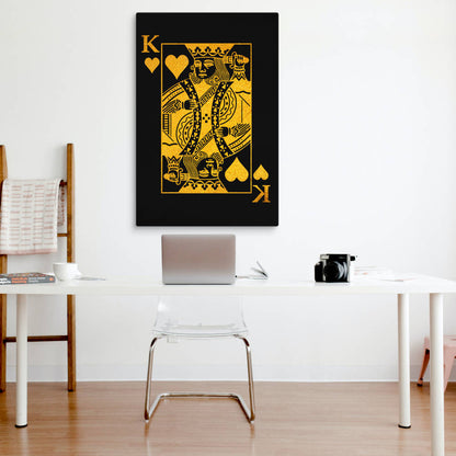 A minimalist workspace with a sleek, black and gold King of hearts canvas print centered above a clean desk setup, blending contemporary art with a functional, stylish office look.
