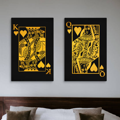 A bedroom setting featuring a pair of bold, black canvas prints with intricate gold playing card designs — a King of Hearts and a Queen of Hearts — hanging above the bed, creating a modern, luxurious vibe.