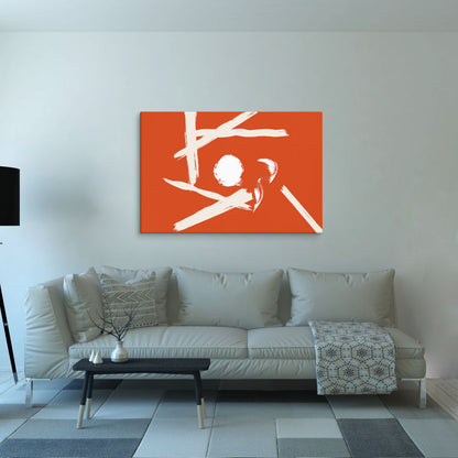 A vibrant orange abstract canvas print with bold white brushstrokes is displayed above a stylish gray sofa. The cool-toned decor provides a clean and neutral background, allowing the artwork's warm hues to stand out.