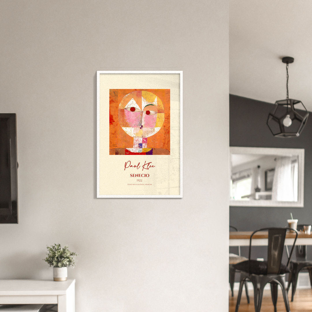 Mockup image of the framed artwork "Senecio" by Paul Klee. The iconic composition features a whimsical face with expressive eyes, showcasing Klee's mastery of geometric abstraction and vibrant colors. The artwork is showcased in a [black/white/red oak] frame, available in various sizes.