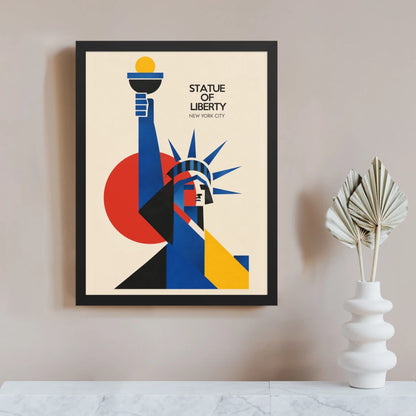 Bauhaus Statue of Liberty poster in a black frame, with the raised torch and crown built from blue, black and yellow geometric forms against a large red circle on a cream background.