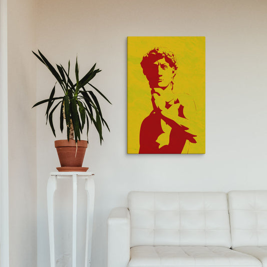Red Classical Statue of David Canvas Print hung above a white sofa with a potted plant, perfect for minimalist retro wall art.

