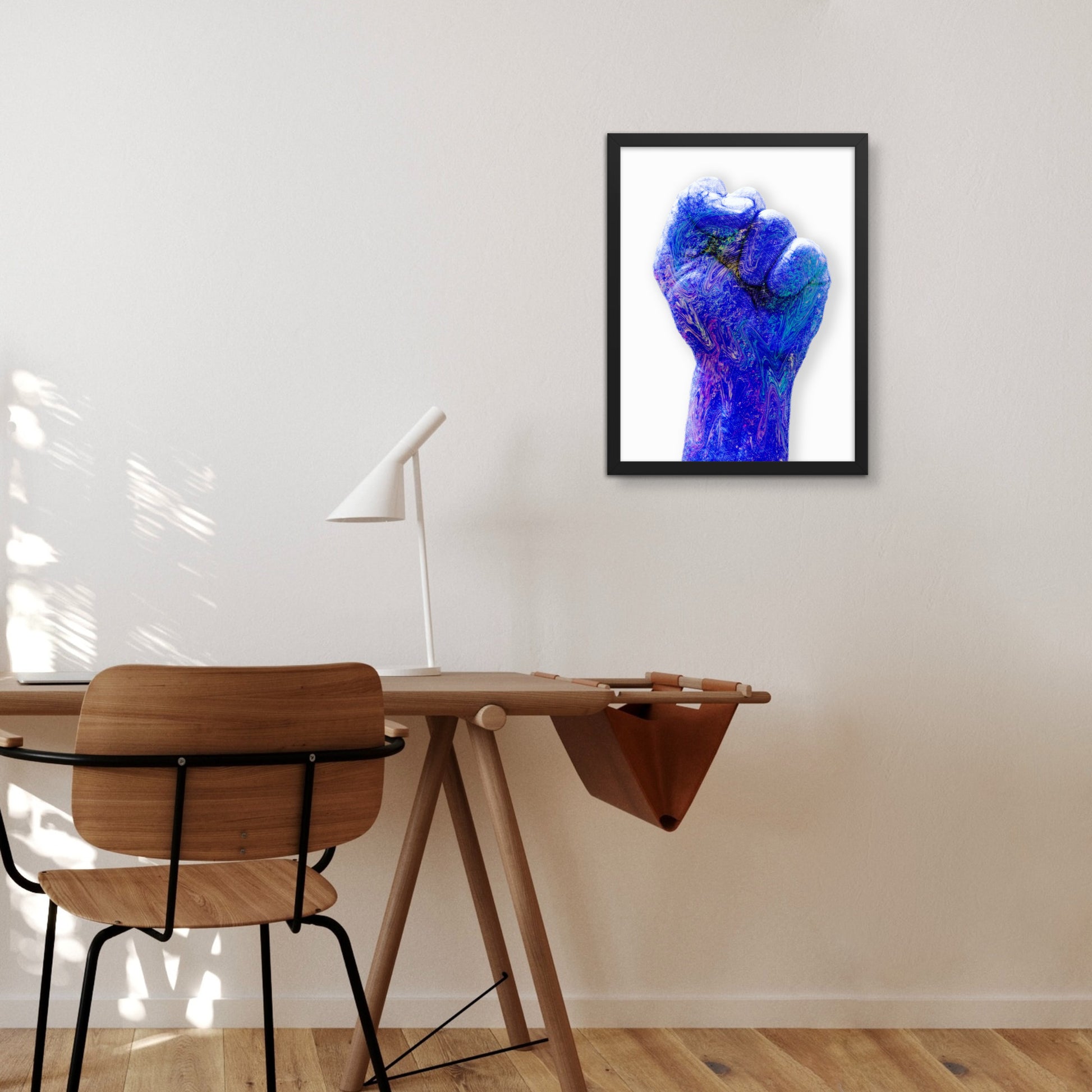 blue raised fist in black frame wall art on wall 